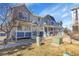 View of multiple townhome exteriors featuring covered front porches, grassy yards, and rock landscaping at 19152 E Wyoming Pl # 102, Aurora, CO 80017