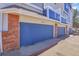 Attached blue painted garage doors on a home with a brick and beige painted exterior at 19152 E Wyoming Pl # 102, Aurora, CO 80017