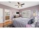 Bedroom with hardwood floors, window, ceiling fan, and ensuite bathroom at 860 Bristle Pine Cir # A, Highlands Ranch, CO 80129