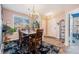 Cozy dining area with a chandelier, large window, and space for a dining set at 860 Bristle Pine Cir # A, Highlands Ranch, CO 80129