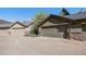 Exterior view of garages with driveways and partial brick siding in residential complex at 860 Bristle Pine Cir # A, Highlands Ranch, CO 80129