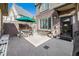 Outdoor patio with dining table, chair, green umbrella, and access to the house at 860 Bristle Pine Cir # A, Highlands Ranch, CO 80129