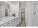 Elegant bathroom with double vanity, modern fixtures, a glass-enclosed shower, and a walk-in closet at 19629 W 93Rd Dr # C, Arvada, CO 80007