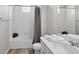 Clean bathroom featuring a shower-tub combo with decorative curtain, and a modern vanity at 19629 W 93Rd Dr # C, Arvada, CO 80007