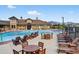 Community pool features lounge chairs, tables and mountain views at 19629 W 93Rd Dr # C, Arvada, CO 80007