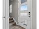 Bright entryway with a modern front door, wood floors, and stairs to the upper level at 19629 W 93Rd Dr # C, Arvada, CO 80007
