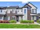 Modern townhome exterior with brick and metal siding, and manicured front lawn at 19629 W 93Rd Dr # C, Arvada, CO 80007
