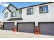 Exterior of townhome with attached garages and red safety posts at 19629 W 93Rd Dr # C, Arvada, CO 80007