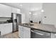 Bright kitchen features stainless steel appliances, granite countertops, and white cabinetry at 19629 W 93Rd Dr # C, Arvada, CO 80007