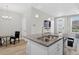 Modern kitchen island with granite countertops, stainless sink, and open-concept layout at 19629 W 93Rd Dr # C, Arvada, CO 80007