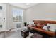 Comfortable living room with a leather futon, neutral decor, and a large window at 19629 W 93Rd Dr # C, Arvada, CO 80007