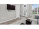 Inviting living room with wood floors, a modern front door, and a mounted TV at 19629 W 93Rd Dr # C, Arvada, CO 80007