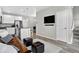 Open-concept living space with a modern kitchen featuring an island, stainless appliances, and wood flooring at 19629 W 93Rd Dr # C, Arvada, CO 80007