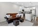 Bright open-concept living space with a modern kitchen featuring an island and stainless appliances at 19629 W 93Rd Dr # C, Arvada, CO 80007