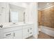 Stylish bathroom with a dual sink vanity, modern fixtures, and tiled shower-tub combo at 39720 Congress Ln, Elizabeth, CO 80107