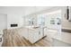 Modern kitchen with a central island, stainless steel appliances, and luxury vinyl flooring at 39720 Congress Ln, Elizabeth, CO 80107