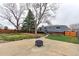 The backyard includes a concrete patio, a fire pit, mature trees, and access to an upper-level deck at 10679 Union Way, Broomfield, CO 80021