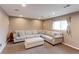 Comfortable finished basement featuring neutral carpet and an overstuffed L-shaped sofa at 10679 Union Way, Broomfield, CO 80021