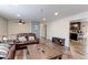 Cozy living room with plush leather sofas, wood floors, and an open layout at 10679 Union Way, Broomfield, CO 80021