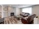 Comfortable living room featuring a decorative fireplace, wood floors, and natural light at 10679 Union Way, Broomfield, CO 80021