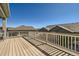 Back deck with white railings overlooks neighboring houses, providing a space for relaxation and entertainment at 12708 Tamarac St, Thornton, CO 80602