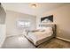 Bright bedroom showcases a large window for natural light, plush carpet, and neutral color palette at 12708 Tamarac St, Thornton, CO 80602