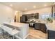 Contemporary kitchen featuring stainless steel appliances, a breakfast bar, and modern finishes at 12708 Tamarac St, Thornton, CO 80602