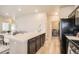 Modern kitchen includes a large island with counter seating, modern appliances, and connects to the dining area at 12708 Tamarac St, Thornton, CO 80602