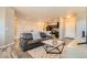 Spacious living room with wood floors, neutral decor, and open access to the dining area and kitchen at 12708 Tamarac St, Thornton, CO 80602