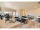 Inviting living room with wood floors, neutral decor, modern furniture, with a dining area in the background at 12708 Tamarac St, Thornton, CO 80602