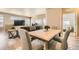 Open-concept living space showcasing a dining area, living room, and a glimpse of the bright workspace at 12708 Tamarac St, Thornton, CO 80602