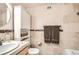 Bathroom featuring stone-look tile, built-in cabinet, and stylish fixtures at 789 N Clarkson St # 705, Denver, CO 80218