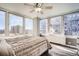Sunlit bedroom features large windows with city views, wood floors and a comfortable bed at 789 N Clarkson St # 705, Denver, CO 80218