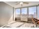 Bright bedroom features hardwood floors, ceiling fan, and large windows offering stunning city views at 789 N Clarkson St # 705, Denver, CO 80218