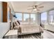Bedroom with city views, wood floors, bedside tables, lamps, and a rustic wooden headboard at 789 N Clarkson St # 705, Denver, CO 80218