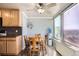 Cozy dining area with ceiling fan, wooden table and chairs, and a large window with city views at 789 N Clarkson St # 705, Denver, CO 80218