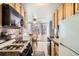 Bright kitchen with stainless steel appliances, granite countertops, and a cozy dining area at 789 N Clarkson St # 705, Denver, CO 80218