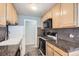 Well-equipped kitchen featuring granite countertops, stainless steel appliances, and ample cabinet space at 789 N Clarkson St # 705, Denver, CO 80218