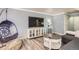 Living area featuring modern decor, a flat-screen TV, and a relaxing swing chair at 789 N Clarkson St # 705, Denver, CO 80218