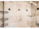 Shower features marble-look tile, recessed shelving, and a handheld shower head at 789 N Clarkson St # 705, Denver, CO 80218