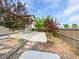 Landscaped backyard with a stone path and covered patio area at 12742 E 104Th Dr, Commerce City, CO 80022