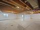 Large unfinished basement with visible ceiling beams and a concrete floor at 12742 E 104Th Dr, Commerce City, CO 80022
