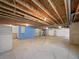Unfinished basement with a blue wall and visible ceiling beams at 12742 E 104Th Dr, Commerce City, CO 80022