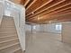 Unfinished basement with exposed ceiling, concrete floor, and stairs at 12742 E 104Th Dr, Commerce City, CO 80022