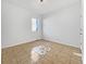 Neutral bedroom features tile flooring, white walls, and a bright window with outdoor view at 12742 E 104Th Dr, Commerce City, CO 80022
