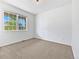 Bright bedroom with neutral carpet, white walls, and a window providing ample natural light at 12742 E 104Th Dr, Commerce City, CO 80022