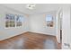 Bright bedroom with hardwood floors and natural light from two large windows at 12742 E 104Th Dr, Commerce City, CO 80022