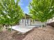 Charming home exterior with a spacious front porch and mature trees at 12742 E 104Th Dr, Commerce City, CO 80022