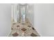 Bright hallway with decorative tile flooring leading into the home at 12742 E 104Th Dr, Commerce City, CO 80022
