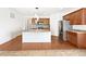 Modern kitchen featuring a center island, stainless steel appliances, and hardwood floors at 12742 E 104Th Dr, Commerce City, CO 80022